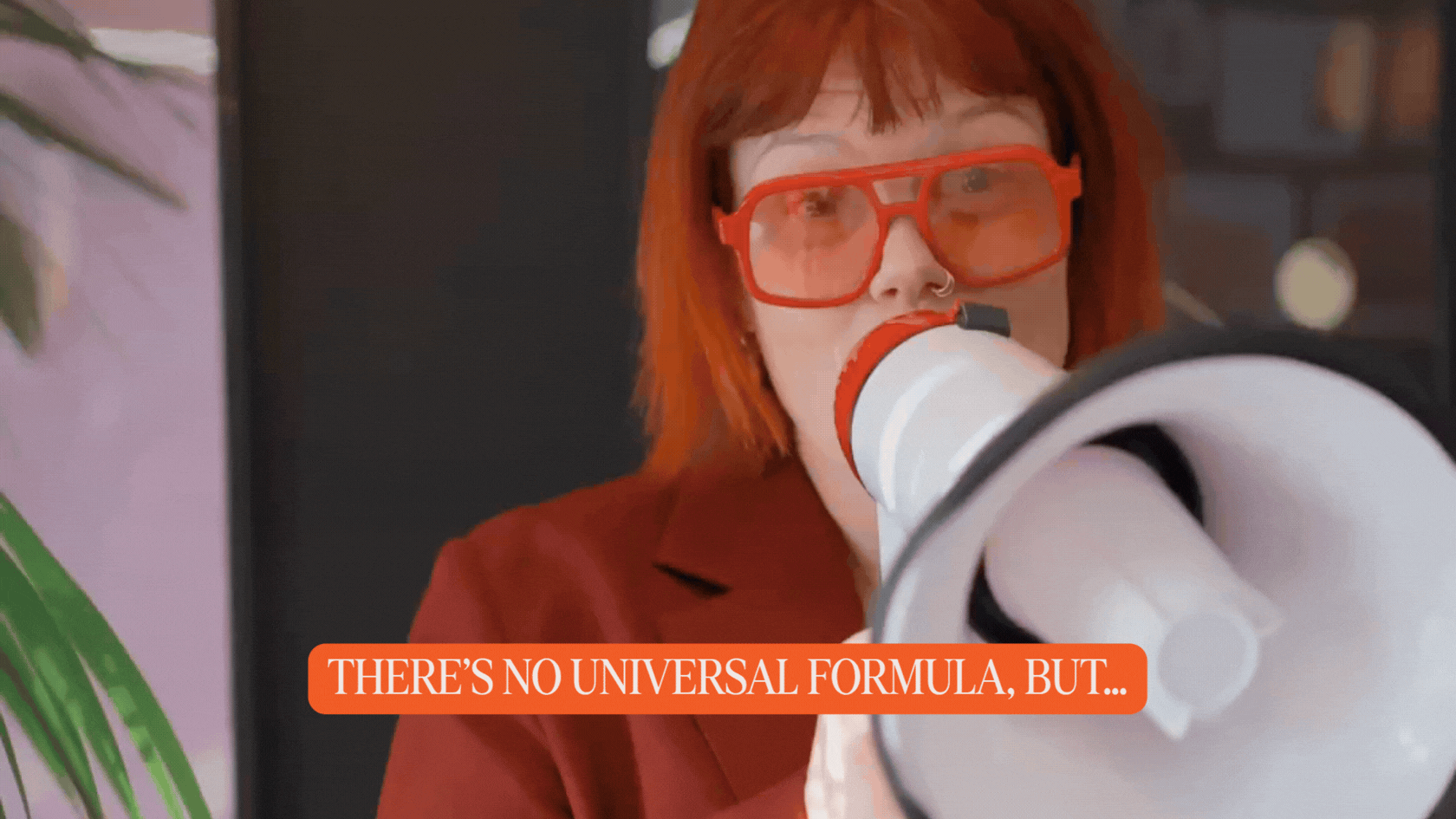 Red-haired woman speaks into a megaphone